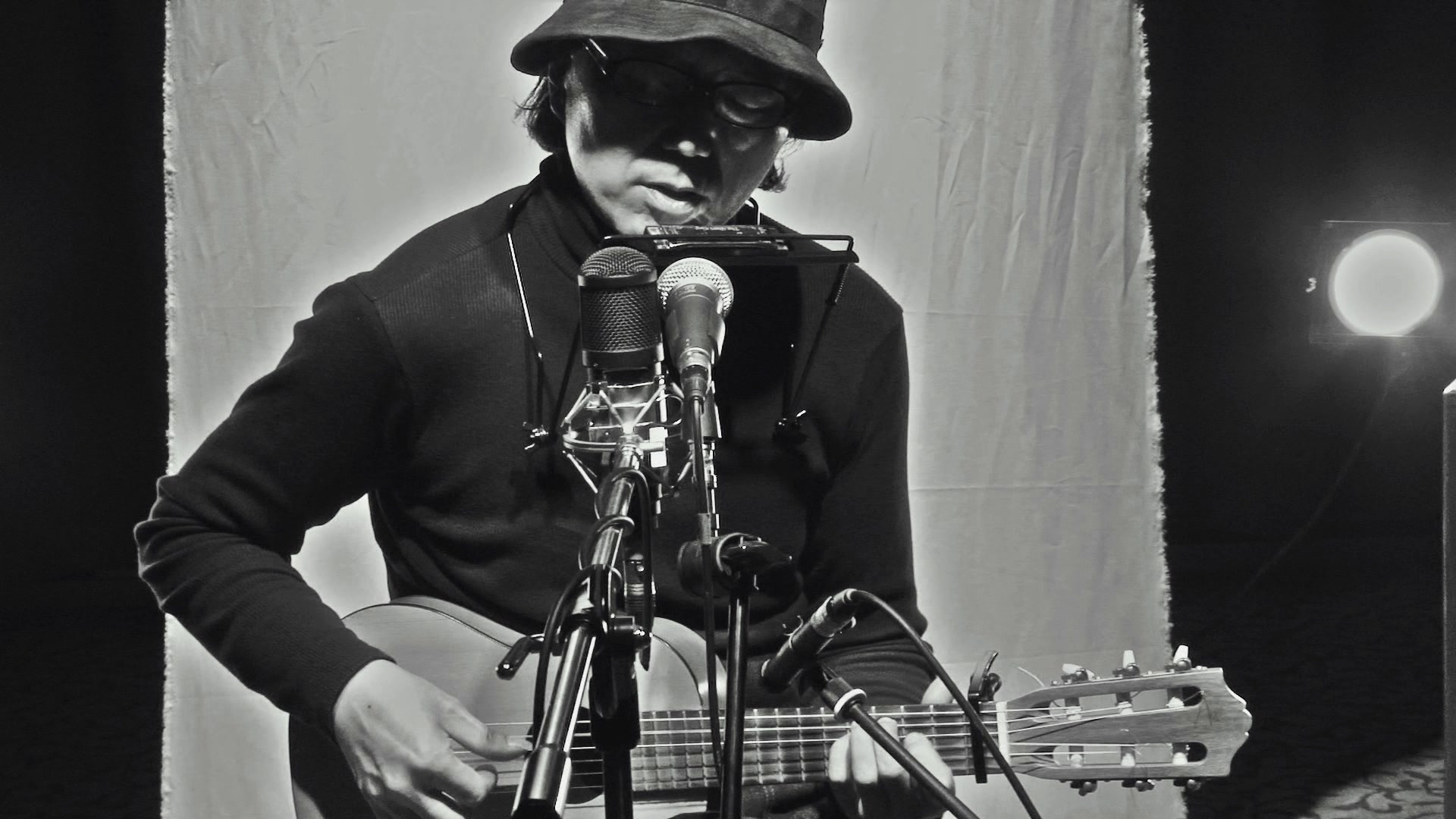 Kim DooSoo plays acoustic guitar.