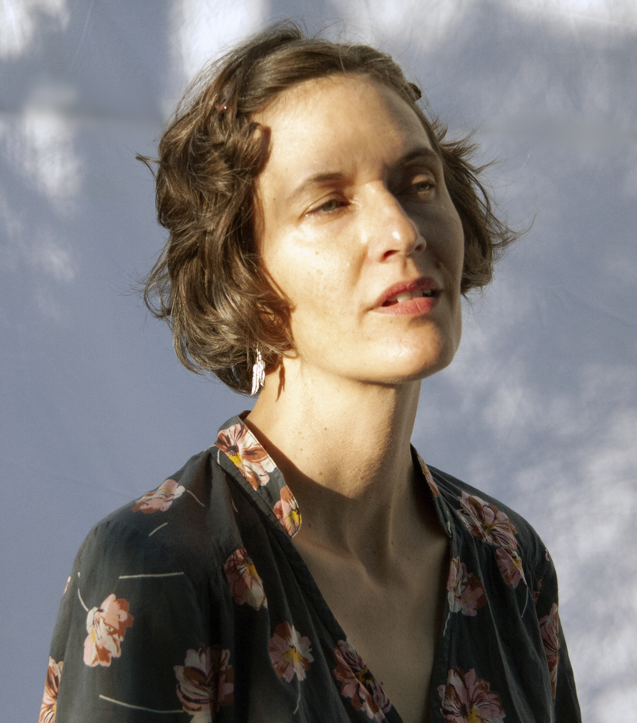 Portrait of Josephine Foster with blue sky and clouds in the background