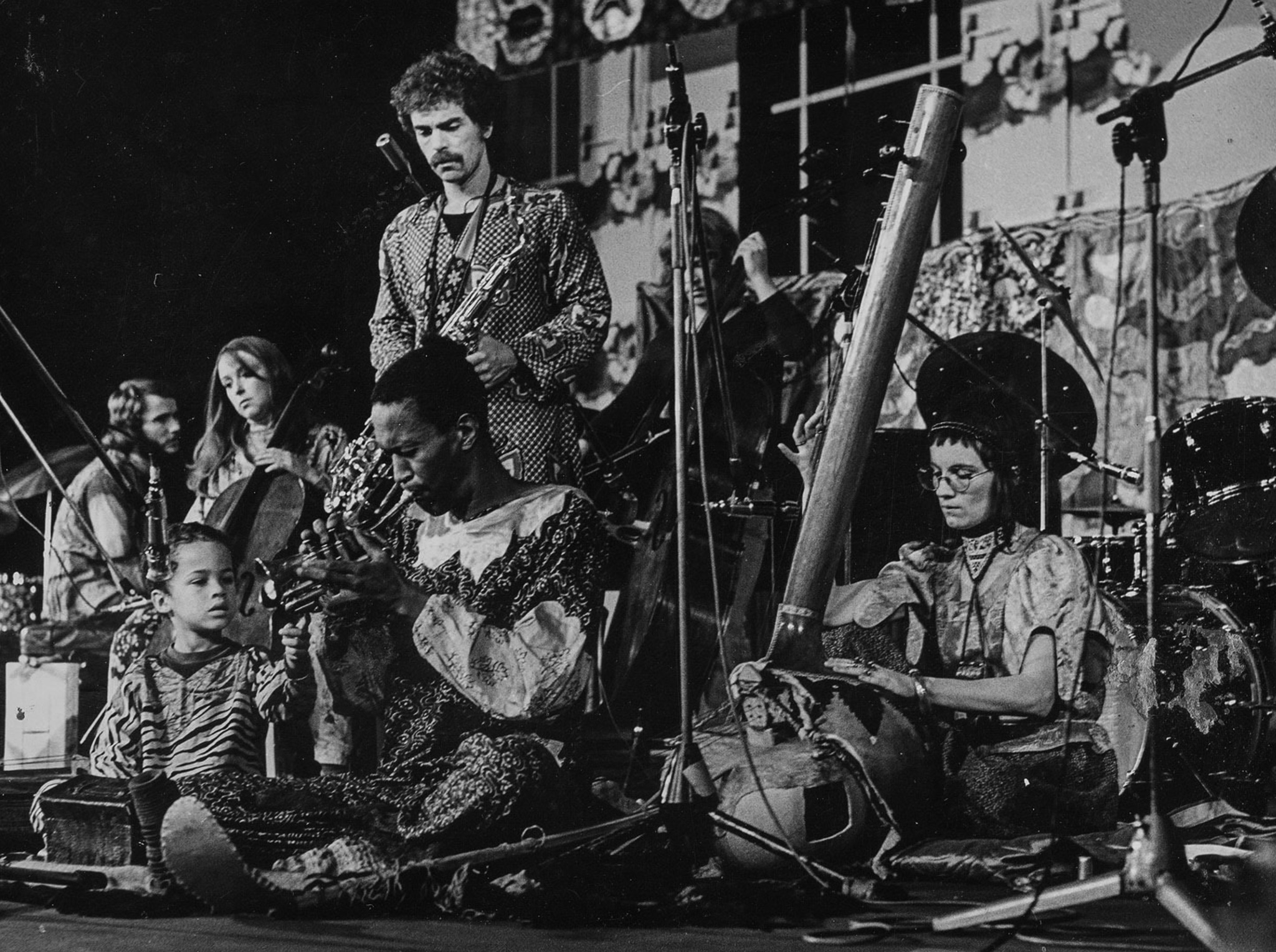 Bobo Stenson (seated on far left), Jan Robertson (cello), Christer Bothén (sax), Eagle-Eye Cherry (seated in foreground), Don Cherry (horn), Palle Danielsson (bass), Moki Cherry (tanpura).