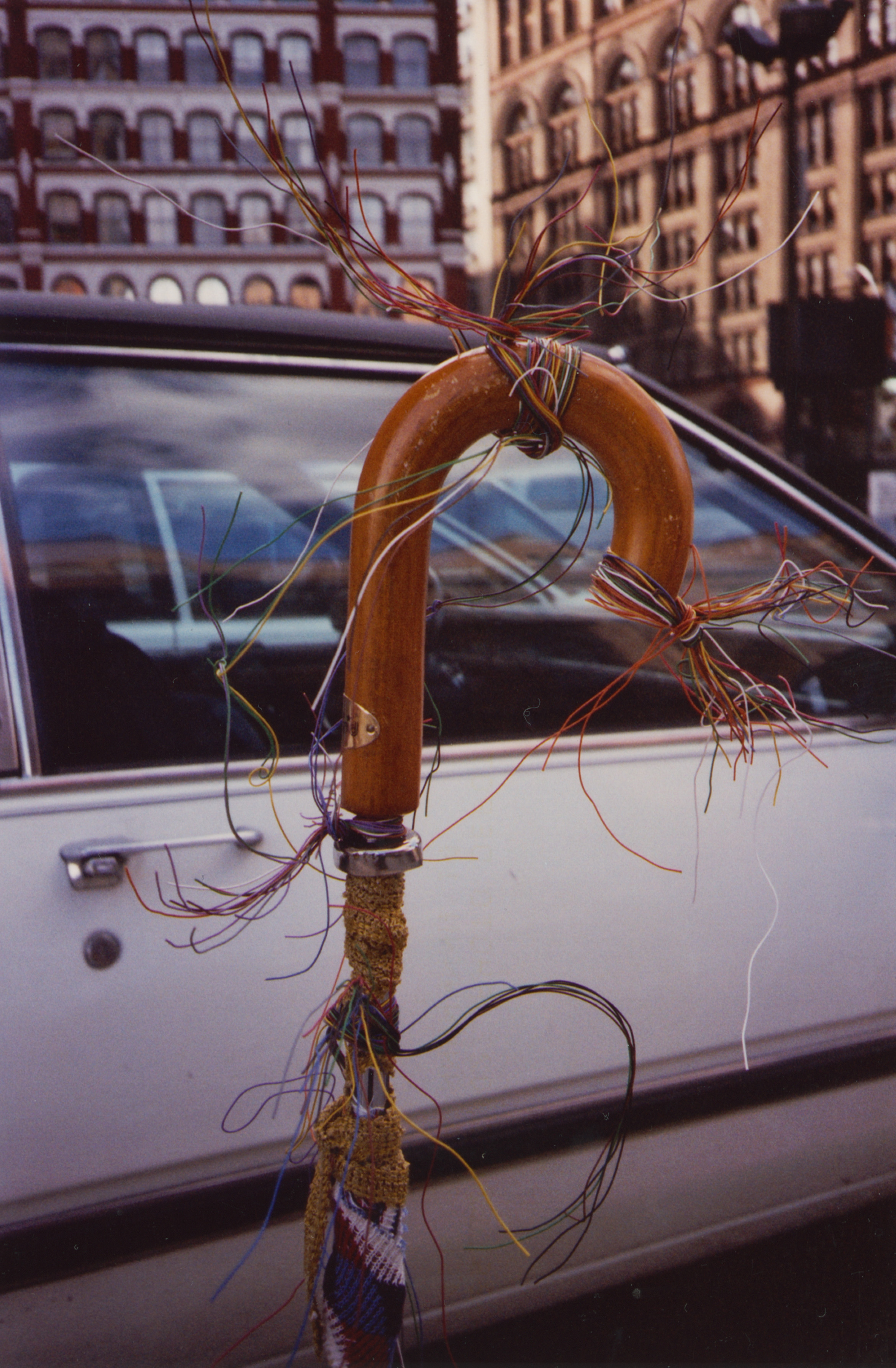 An umbrella hook adorned with twisted electrical wire 