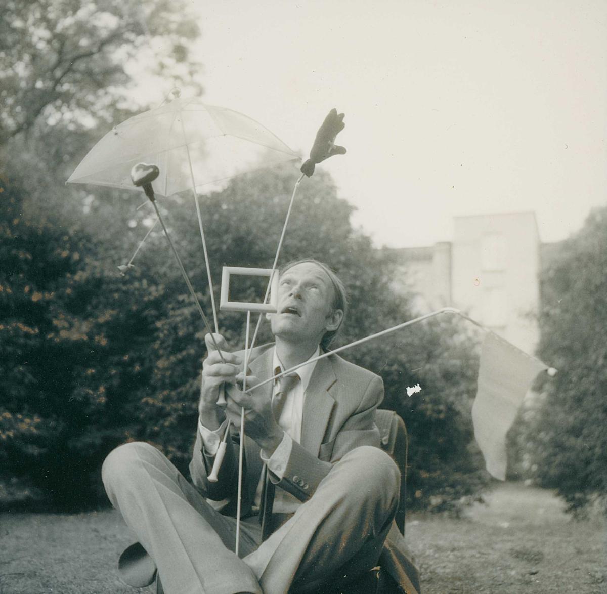 Jerry Hunt seated outside with his wands, 1976.